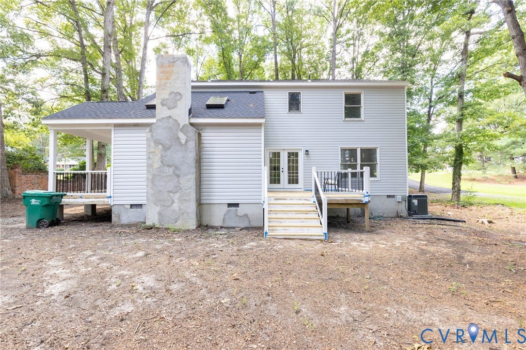 10541 Glencoe Road, Henrico, VA 23060 Rear exterior featuring light-colored siding, a covered porch, a wood deck with stairs, and a visible chimney