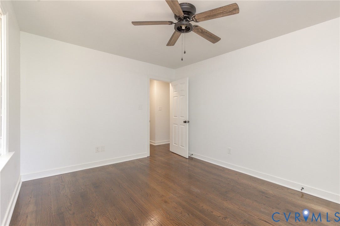 10541 Glencoe Road, Henrico, VA 23060 Wood-finish flooring with white baseboards, a white door frame, and a ceiling fan with wood-look blades