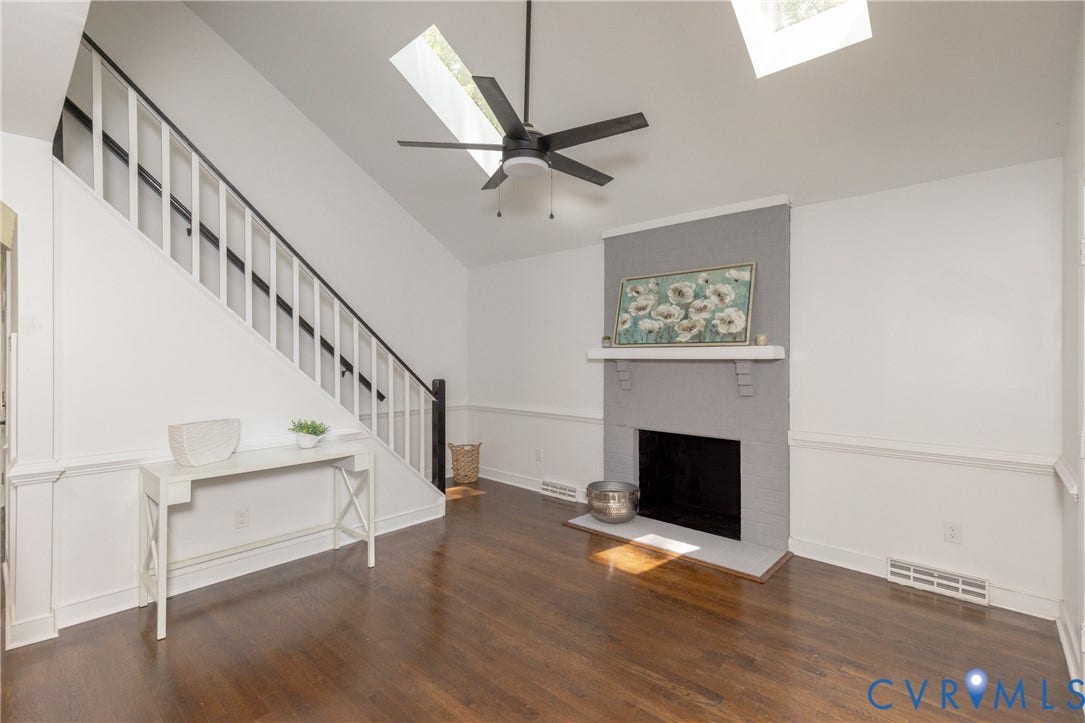 10541 Glencoe Road, Henrico, VA 23060 Wood-finish flooring, wainscoting, a painted brick fireplace with mantel, and a ceiling fan