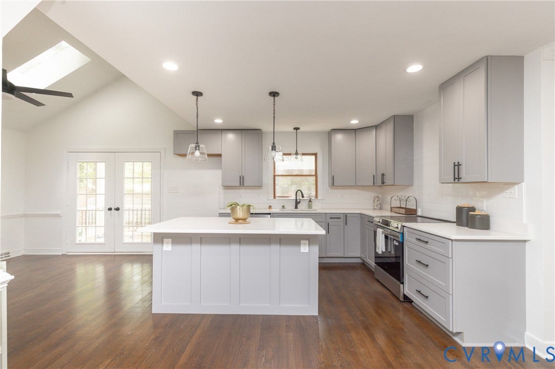 10541 Glencoe Road, Henrico, VA 23060 Vaulted ceiling with skylight and ceiling fan, wood-finish flooring, white French doors, center island, and grey cabinetry