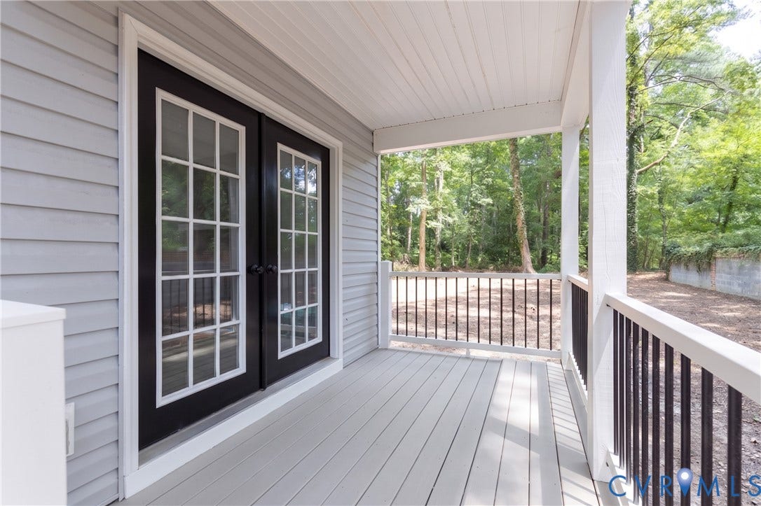10541 Glencoe Road, Henrico, VA 23060 Covered porch featuring light gray wood-finish decking, white railings with dark balusters, and a panelled ceiling