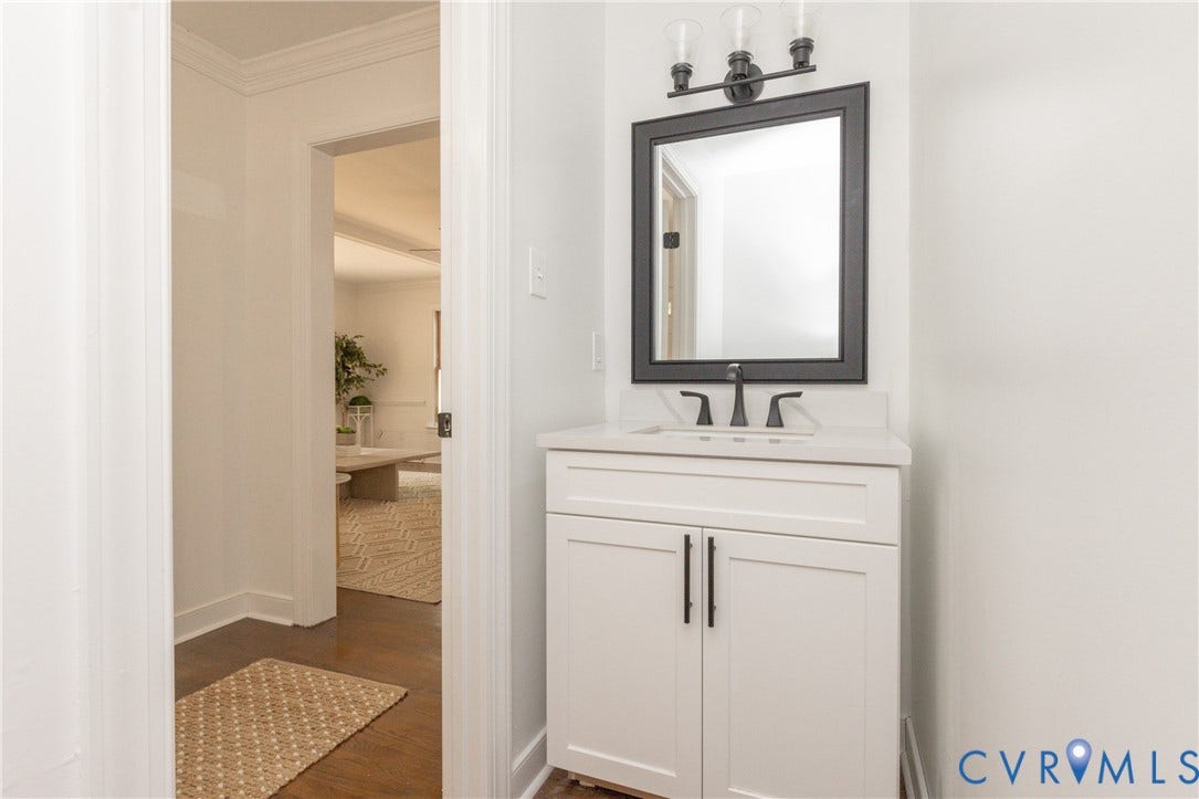 10541 Glencoe Road, Henrico, VA 23060 White vanity with dark hardware, undermount sink, dark faucet, and rectangular mirror with a dark frame