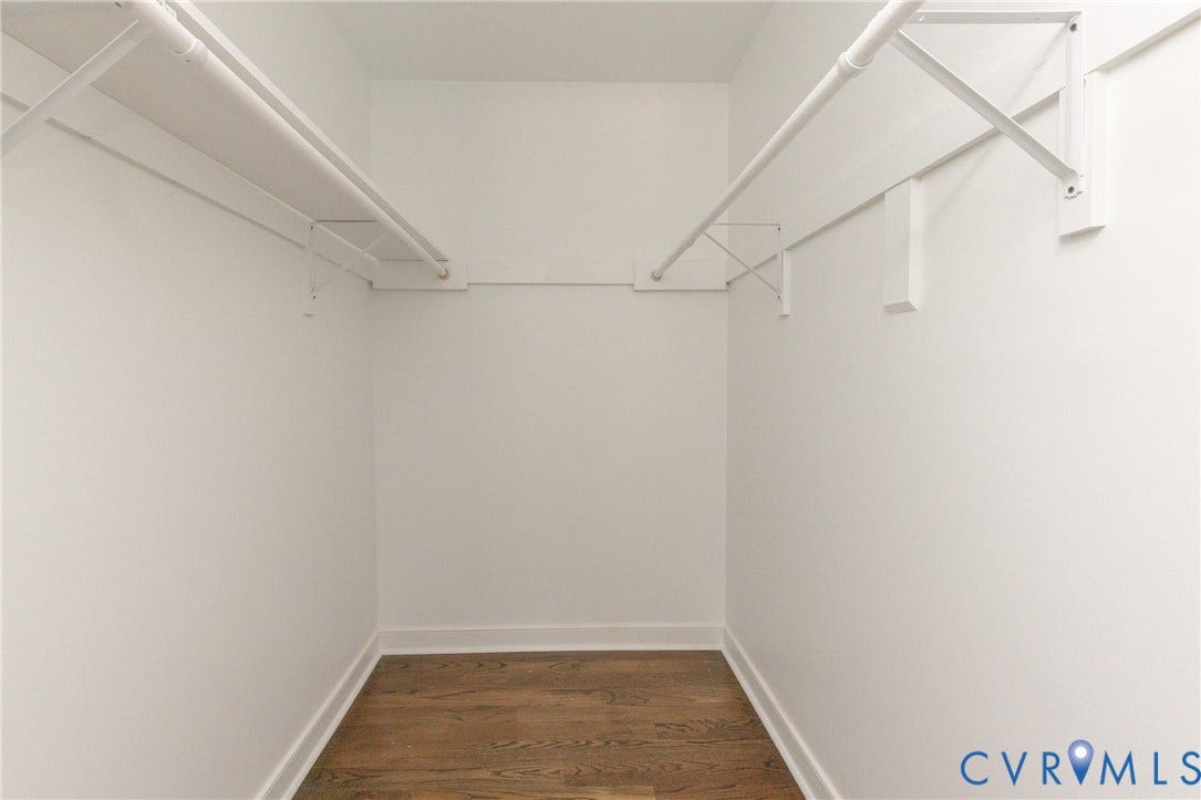 10541 Glencoe Road, Henrico, VA 23060 Walk-in closet featuring wood-finish flooring, white walls, and dual clothing rods with shelving