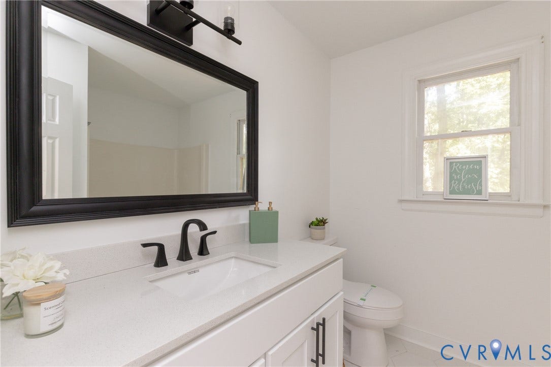 10541 Glencoe Road, Henrico, VA 23060 White vanity with dark hardware, a white countertop, and a single basin sink