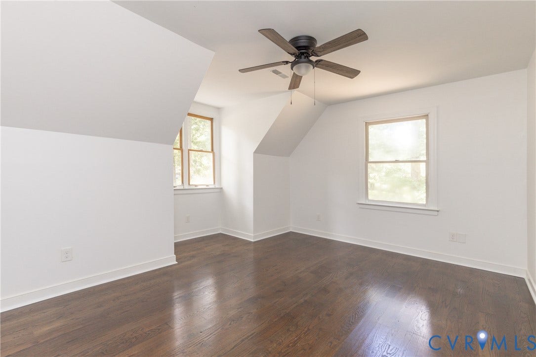 10541 Glencoe Road, Henrico, VA 23060 Hardwood-style flooring, angled ceilings, two windows with trim, and a ceiling fan with light fixture