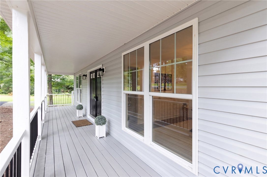 10541 Glencoe Road, Henrico, VA 23060 Expansive covered porch featuring a composite deck, white columns, black railing, and gray siding