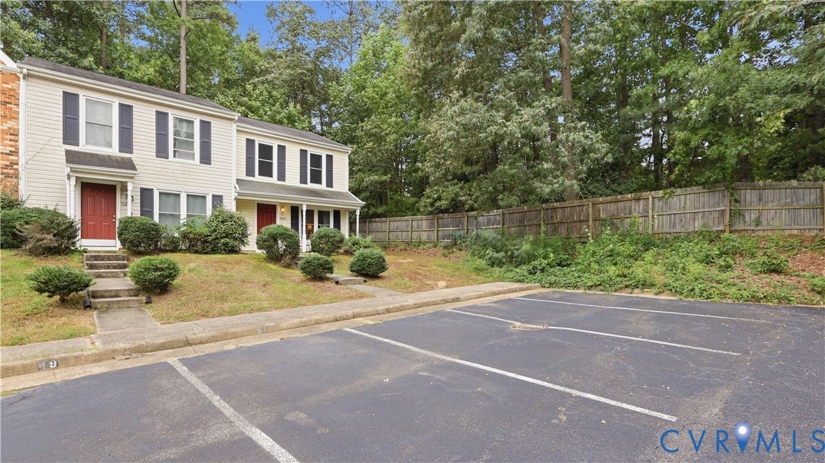 15253 Broadwater Circle, Chester, VA 23831 Siding exterior featuring dark shutters, red entry doors, and shrubbery landscaping