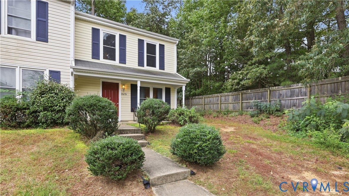 15253 Broadwater Circle, Chester, VA 23831 Light-colored siding exterior with a red front door, blue window shutters, and a covered entry