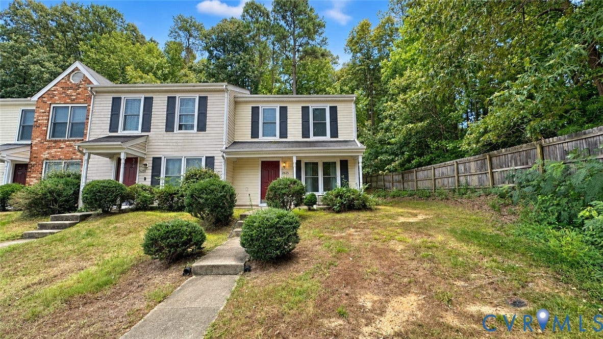 15253 Broadwater Circle, Chester, VA 23831 Two-story townhouse with light-toned siding, dark shutters, and a covered entry