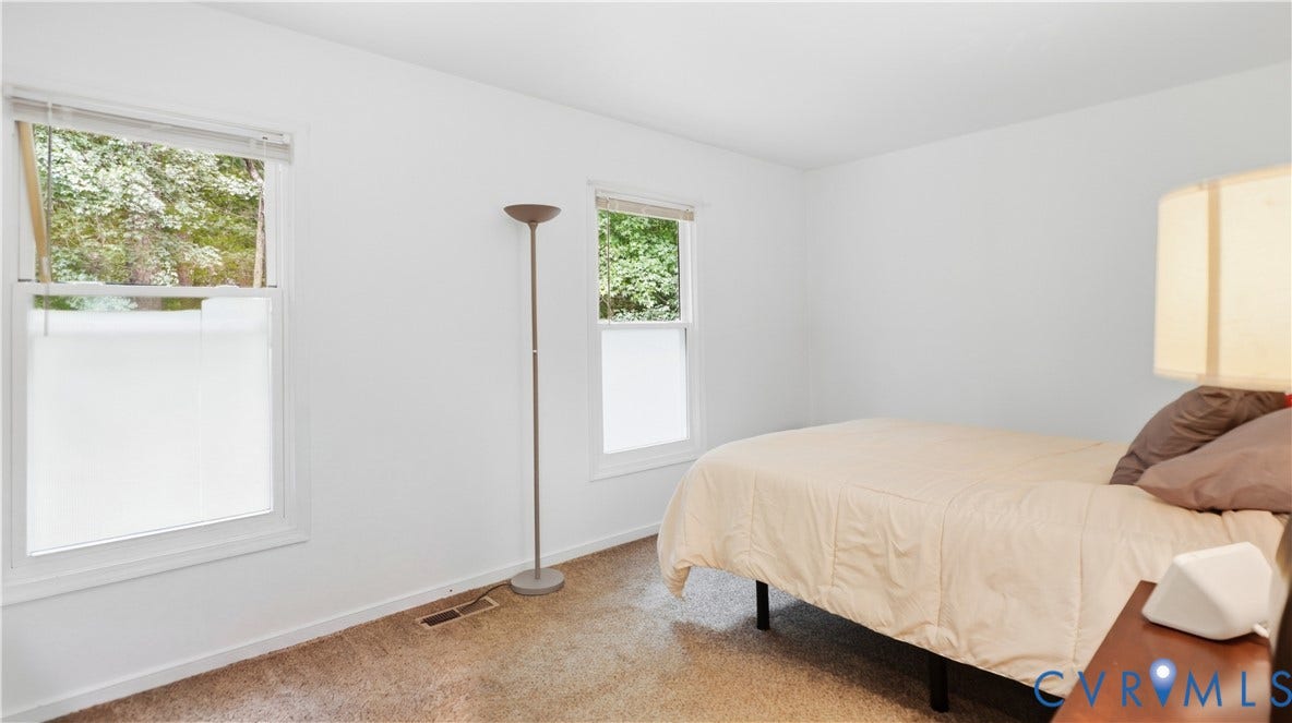 15253 Broadwater Circle, Chester, VA 23831 Two windows with white trim, white walls, and carpeting
