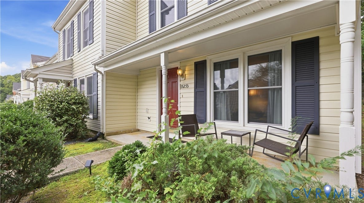 15253 Broadwater Circle, Chester, VA 23831 Inviting covered front porch with decorative columns, light-toned siding, and dark louvered shutters