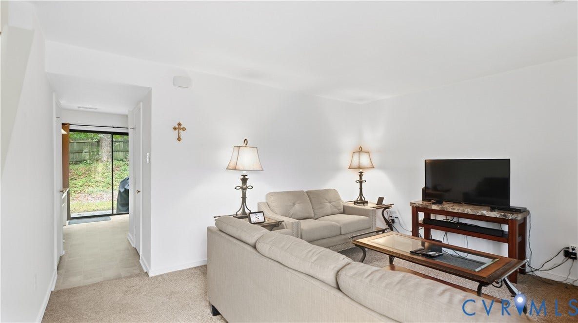 15253 Broadwater Circle, Chester, VA 23831 Light-colored carpeting, white painted walls, and a sliding glass door providing exterior access