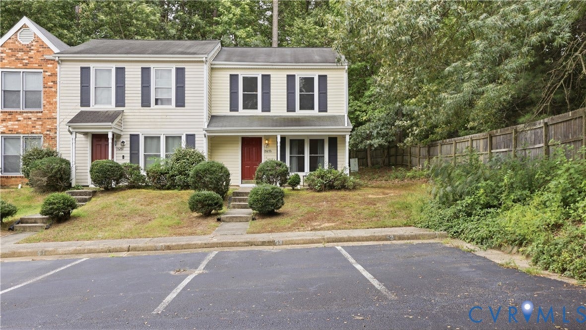 15253 Broadwater Circle, Chester, VA 23831 Two-story townhouse with light-colored siding, dark shutters, and a red entry door