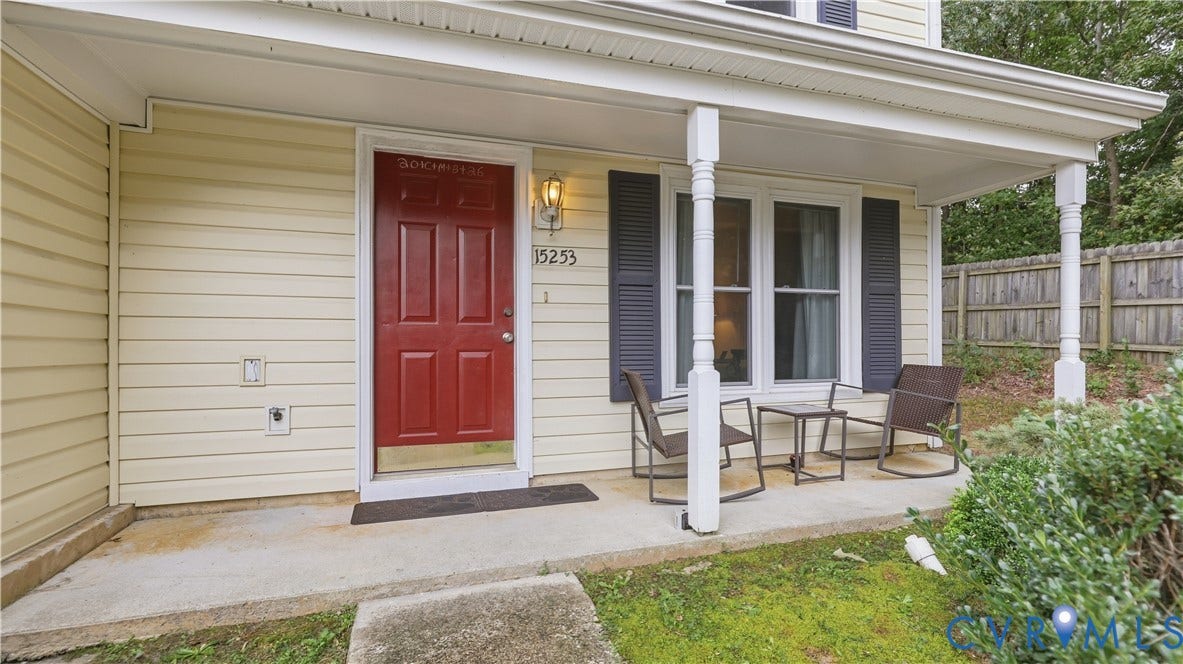 15253 Broadwater Circle, Chester, VA 23831 Covered porch with decorative columns, light-colored siding, and a red paneled entry door