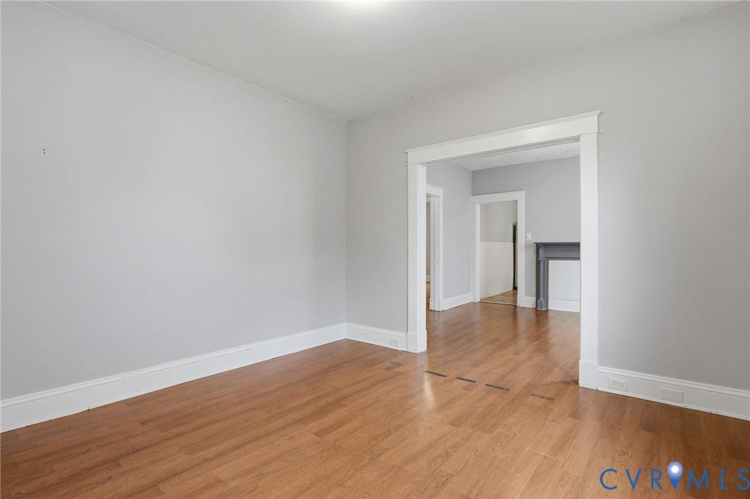 Wood-finish flooring with light gray wall tones and white trim