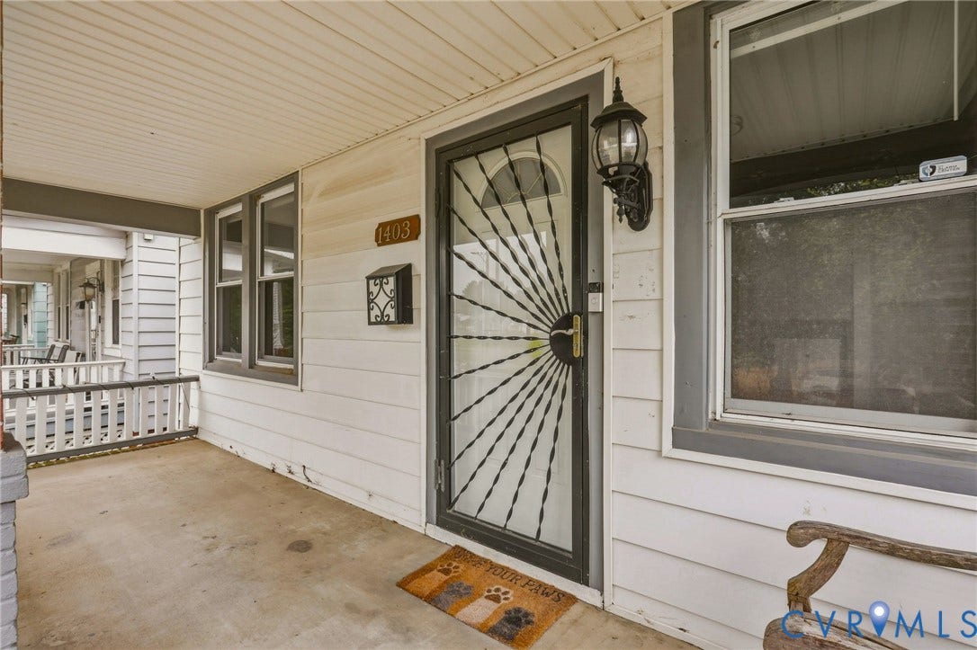 Covered front porch with white siding exterior