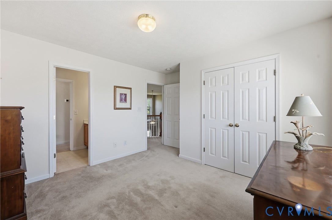 Bright secondary bedroom with natural light and direct access to the shared hallway bathroom