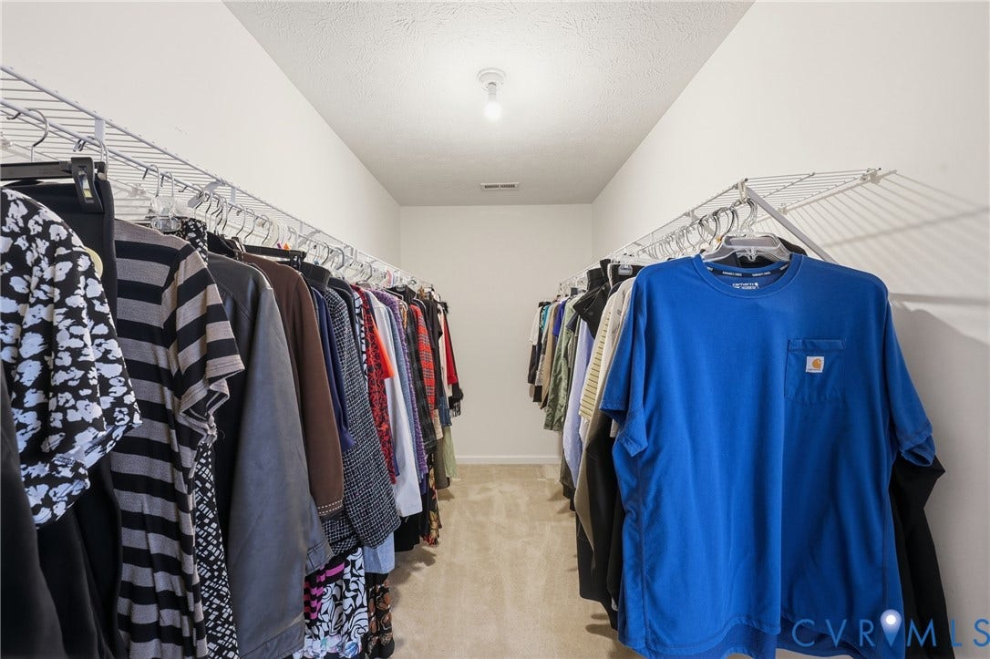 A generous walk-in closet adds practical storage to the home's convenient first-floor primary suite