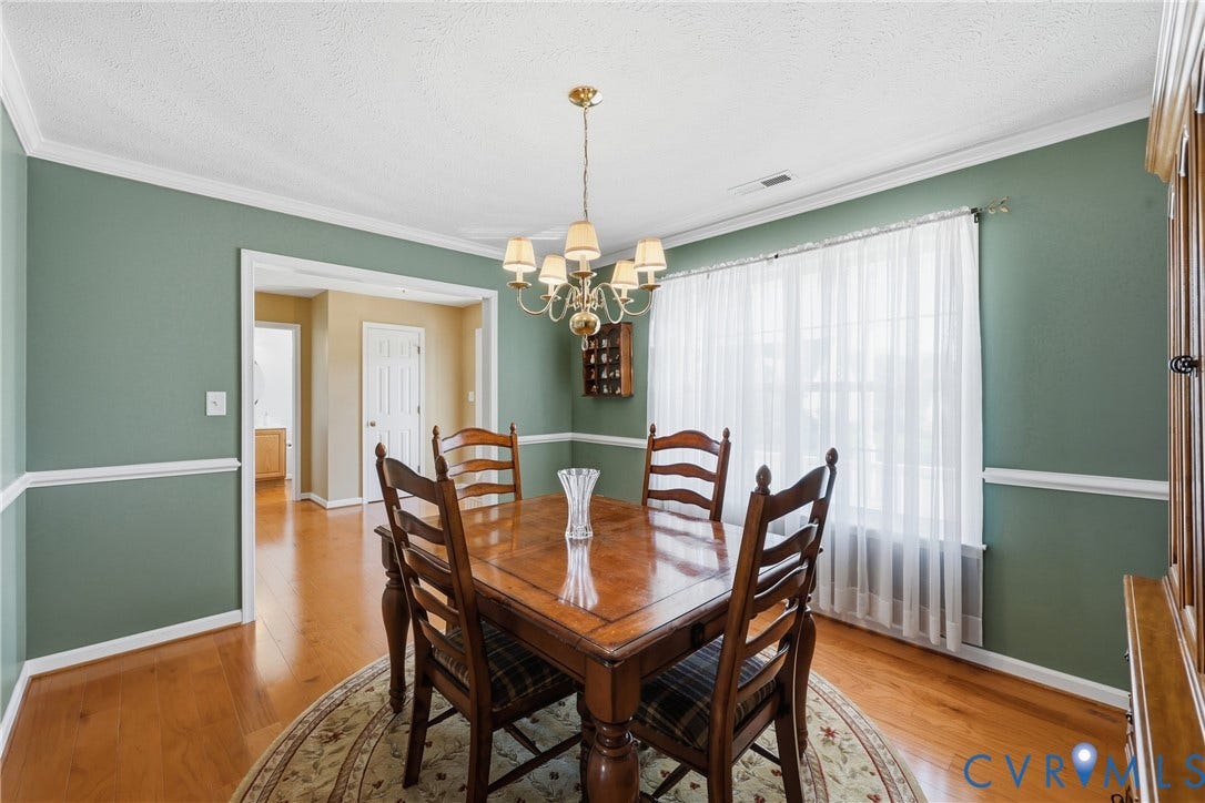 Dedicated dining room with hardwood floors and classic trim, ready for holiday meals and memorable gatherings.