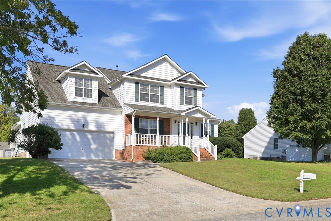 Beautiful 2-story Williamsburg home with attached 2-car garage, covered entry, and spacious front lawn