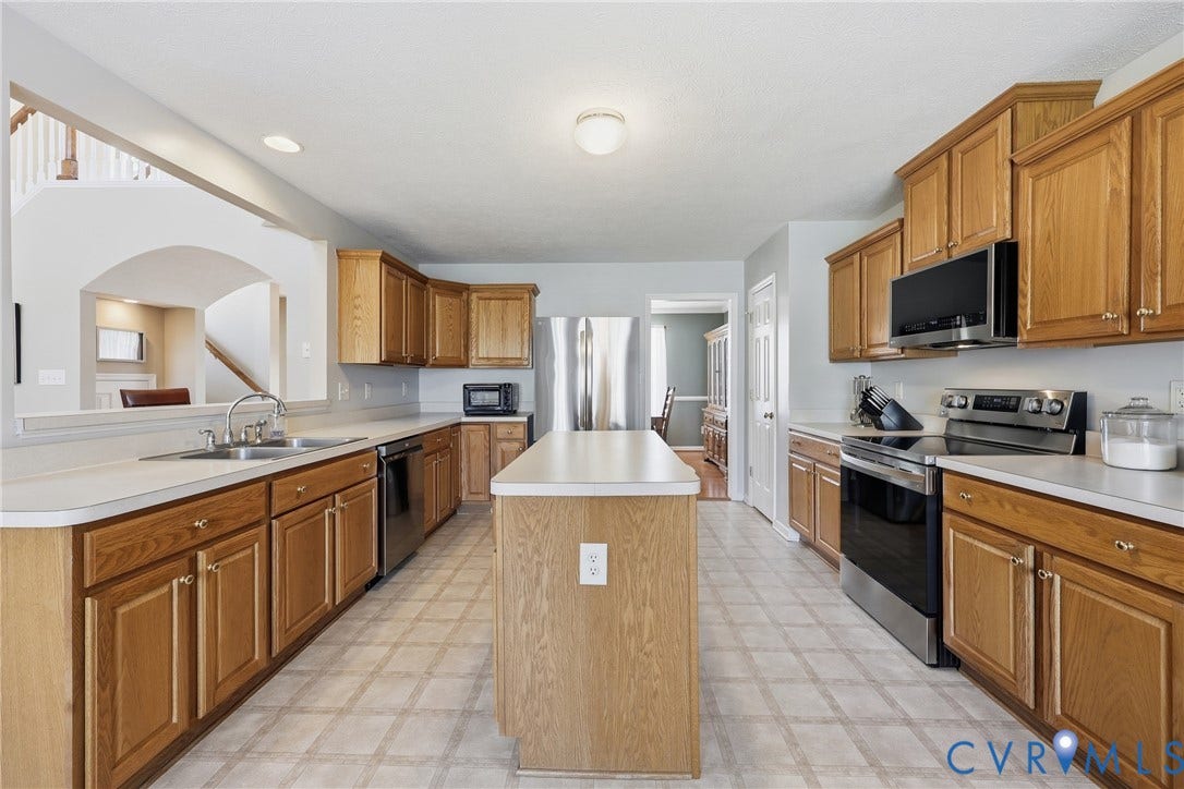 A spacious kitchen offers plenty of room to prepare meals, gather at the island, and enjoy casual dining