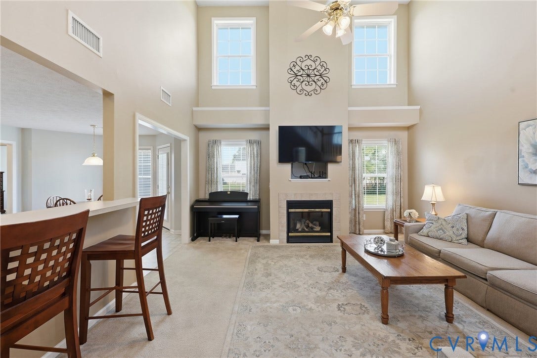 Gas fireplace framed by large windows creates a natural focal point
