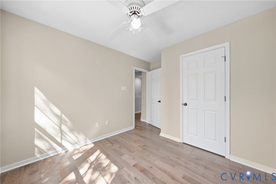 1852 Timberly Waye, Henrico, VA 23238 Neutral wall paint, ceiling fan, wood-finish flooring, white paneled doors, and white trim