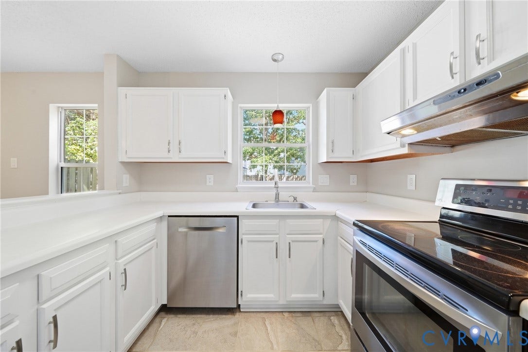 1852 Timberly Waye, Henrico, VA 23238 White cabinetry, light-toned countertops, stainless steel appliances, tile flooring, and a kitchen window