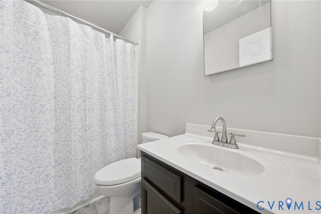 1852 Timberly Waye, Henrico, VA 23238 Recessed sink with a brushed nickel faucet, dark wood-finish vanity, and a rectangular mirror