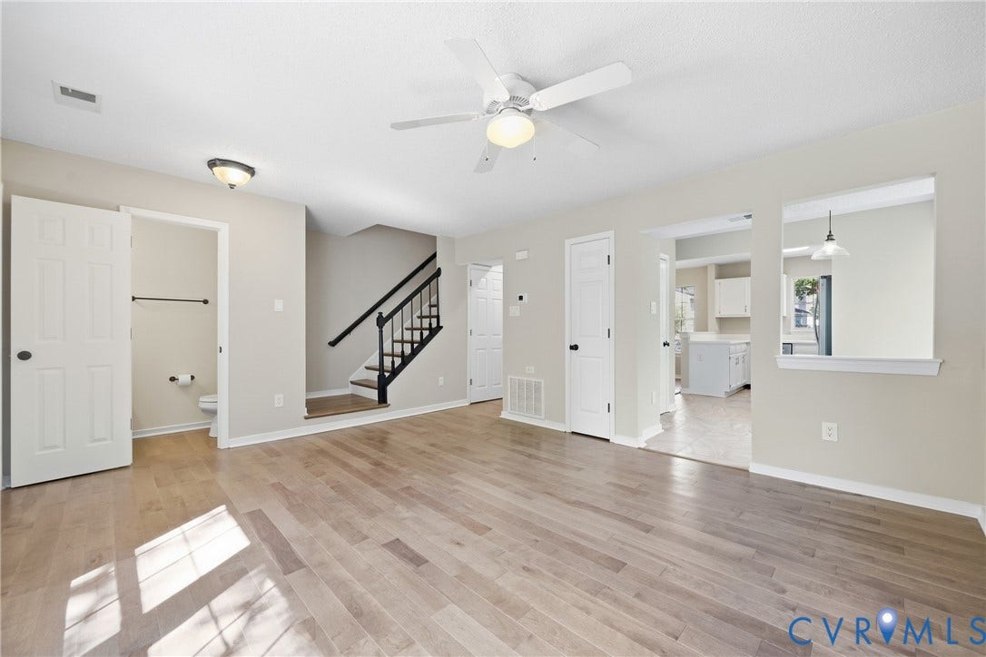 1852 Timberly Waye, Henrico, VA 23238 Wood-finish flooring throughout, ceiling fan with integrated lighting, and a staircase with a black banister