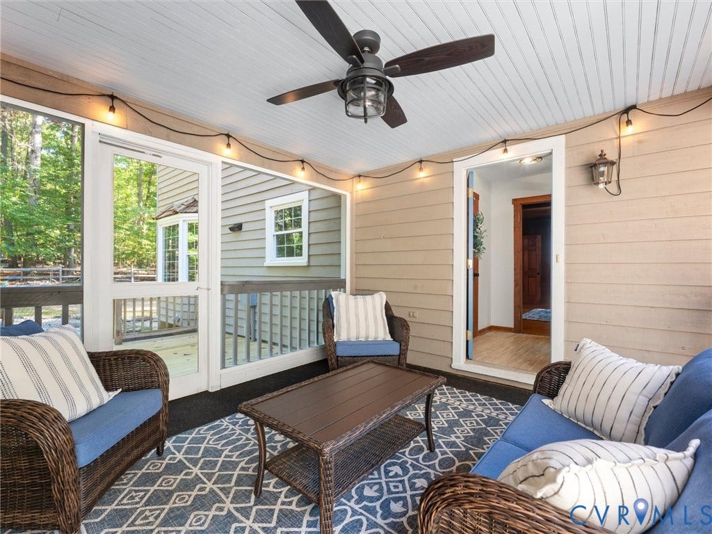 3801 Old River Trail, Powhatan, VA 23139 Screened porch featuring horizontal lap siding, beadboard ceiling, dark finish ceiling fan, and string lighting
