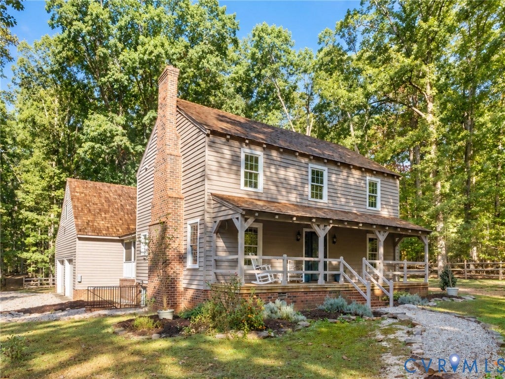 3801 Old River Trail, Powhatan, VA 23139 Two-story home with horizontal siding, cedar shake roofing, exterior brick chimney, and a covered front porch with timber framing