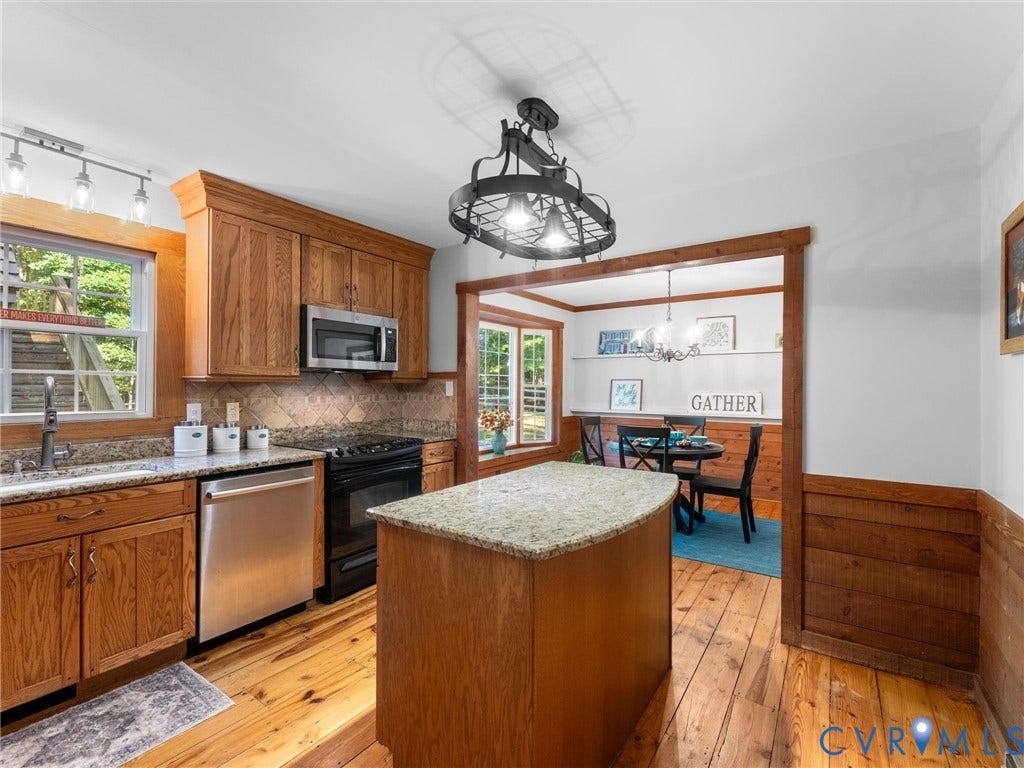 3801 Old River Trail, Powhatan, VA 23139 Kitchen featuring wood cabinetry, stone-surface countertops, central island, stainless steel appliances, and wood-finish flooring