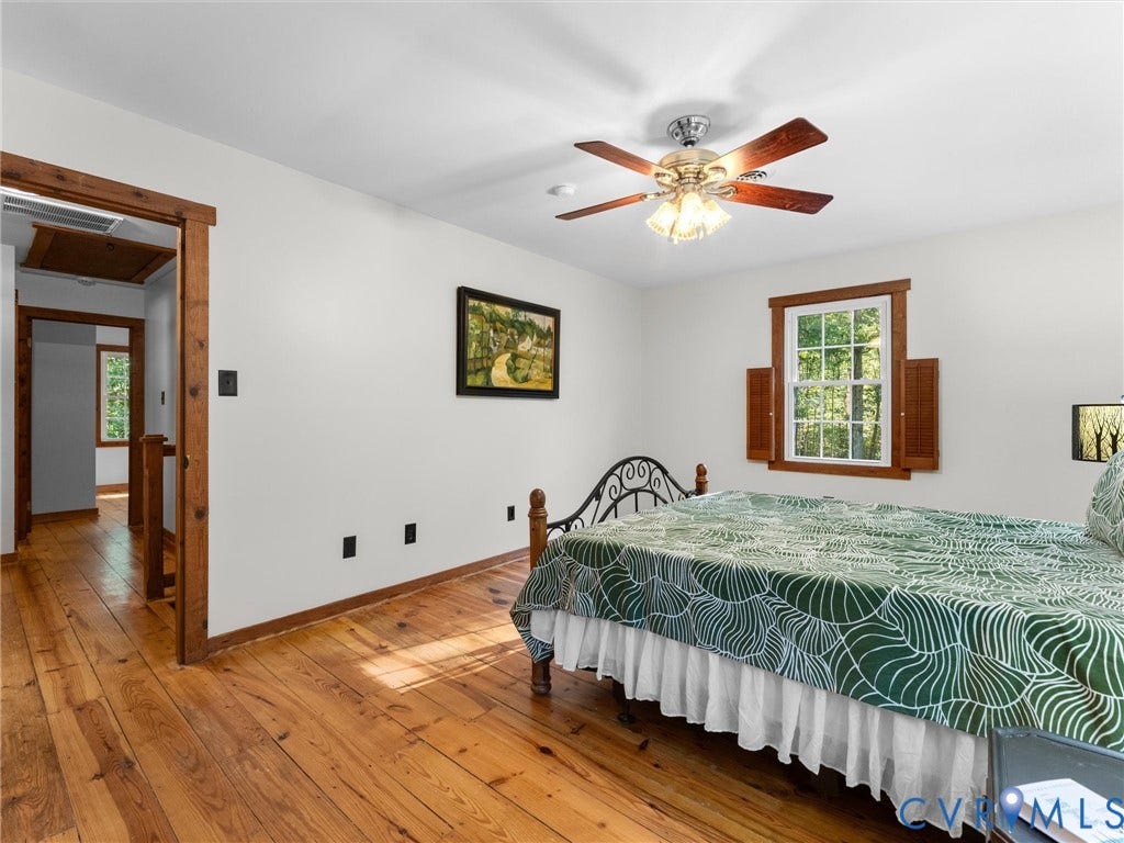 3801 Old River Trail, Powhatan, VA 23139 Room featuring wood-finish flooring, natural wood door and window casing, multi-pane window with wood shutters, and a ceiling-mounted light fixture with fan blades