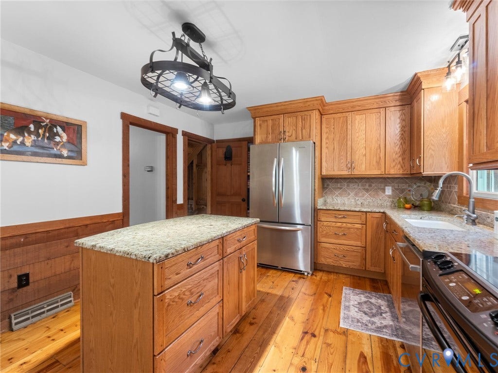 3801 Old River Trail, Powhatan, VA 23139 Kitchen featuring wood cabinetry, stone countertops, central island, wood-finish flooring, and decorative metal chandelier