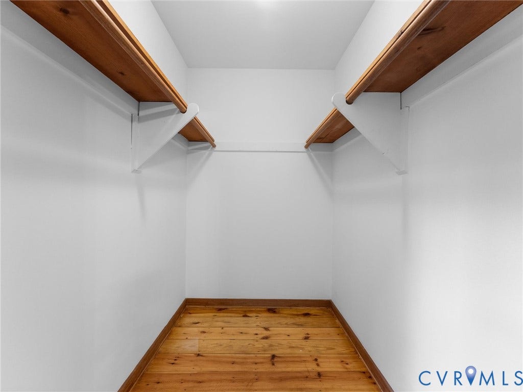3801 Old River Trail, Powhatan, VA 23139 Storage space featuring wood-finish flooring and dual-level wood shelving supported by painted brackets