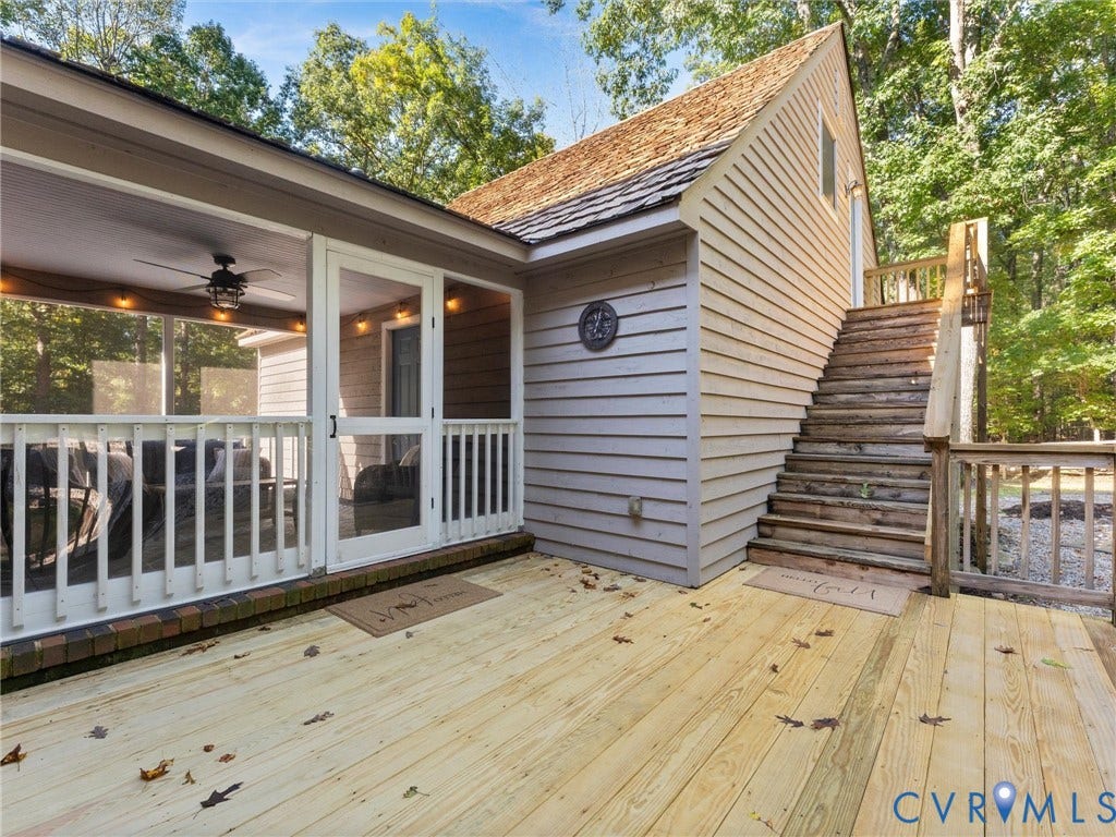 3801 Old River Trail, Powhatan, VA 23139 Spacious wood deck featuring a screened-in porch with a ceiling fan, exterior wood stairs, and siding