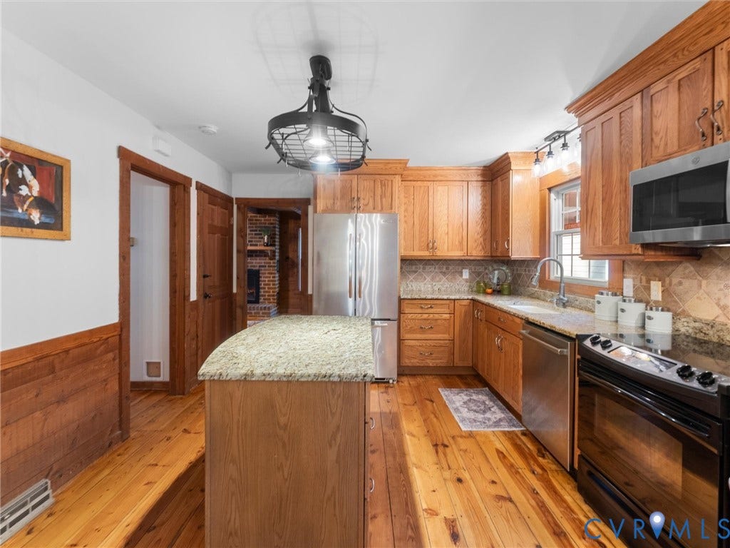3801 Old River Trail, Powhatan, VA 23139 Kitchen featuring custom oak cabinetry, stone-surface countertops, central island, wood-finish flooring, and stainless steel appliances