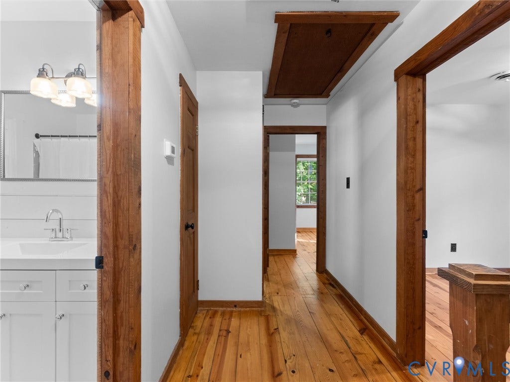 3801 Old River Trail, Powhatan, VA 23139 Hallway featuring wood-finish flooring, stained wood door frames, and a recessed ceiling access panel