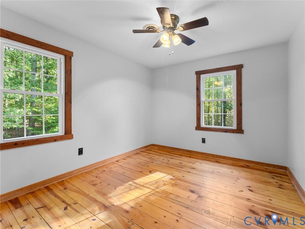 3801 Old River Trail, Powhatan, VA 23139 Natural wood-finish flooring, double-hung windows with stained wood trim, and a multi-light ceiling fan fixture
