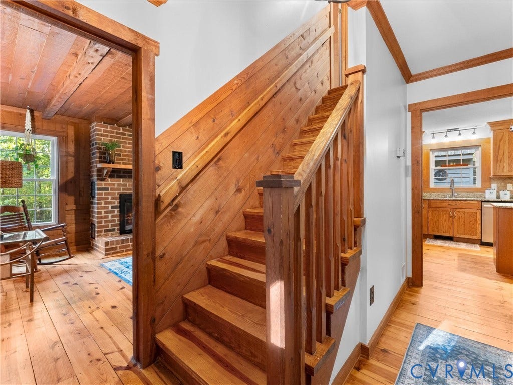 3801 Old River Trail, Powhatan, VA 23139 Staircase featuring natural wood paneling, matching wood handrail and balusters, wood-finish flooring, and crown molding