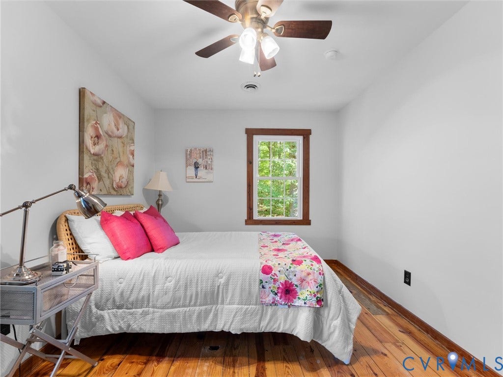 3801 Old River Trail, Powhatan, VA 23139 Room featuring natural wood flooring, a ceiling fan with integrated lighting, and a window framed in stained wood trim