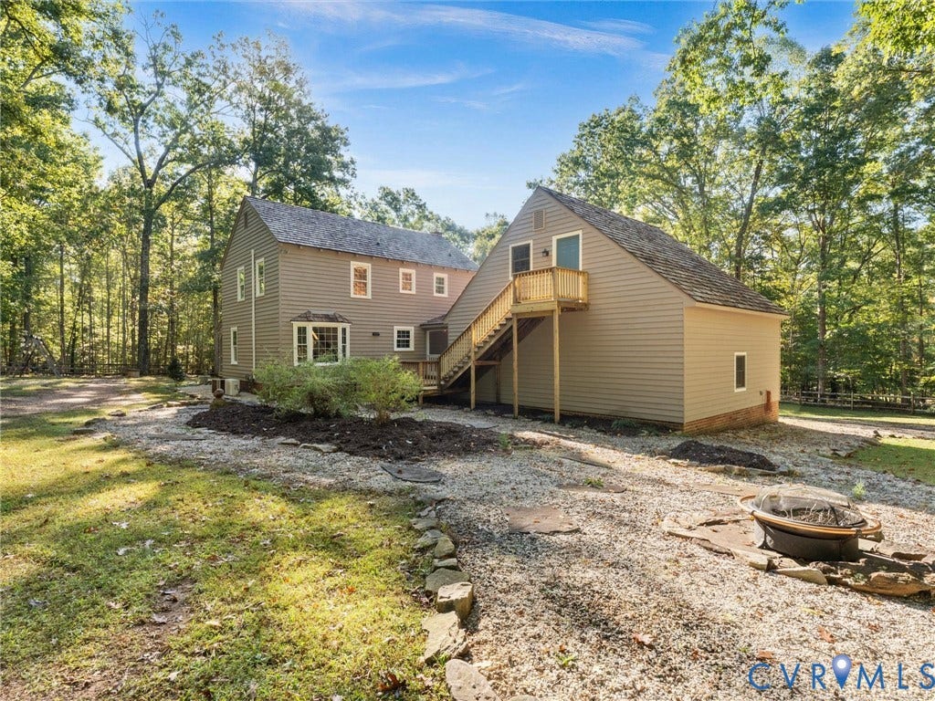 3801 Old River Trail, Powhatan, VA 23139 Multi-story exterior featuring wood-style siding, a cedar shake roof, bay window, and a wooden exterior staircase