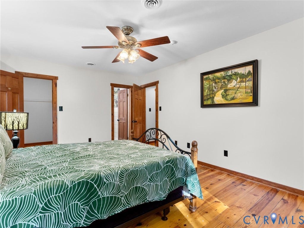 3801 Old River Trail, Powhatan, VA 23139 Room featuring wood-finish flooring, natural wood door trim, and a multi-blade ceiling fan with integrated lighting