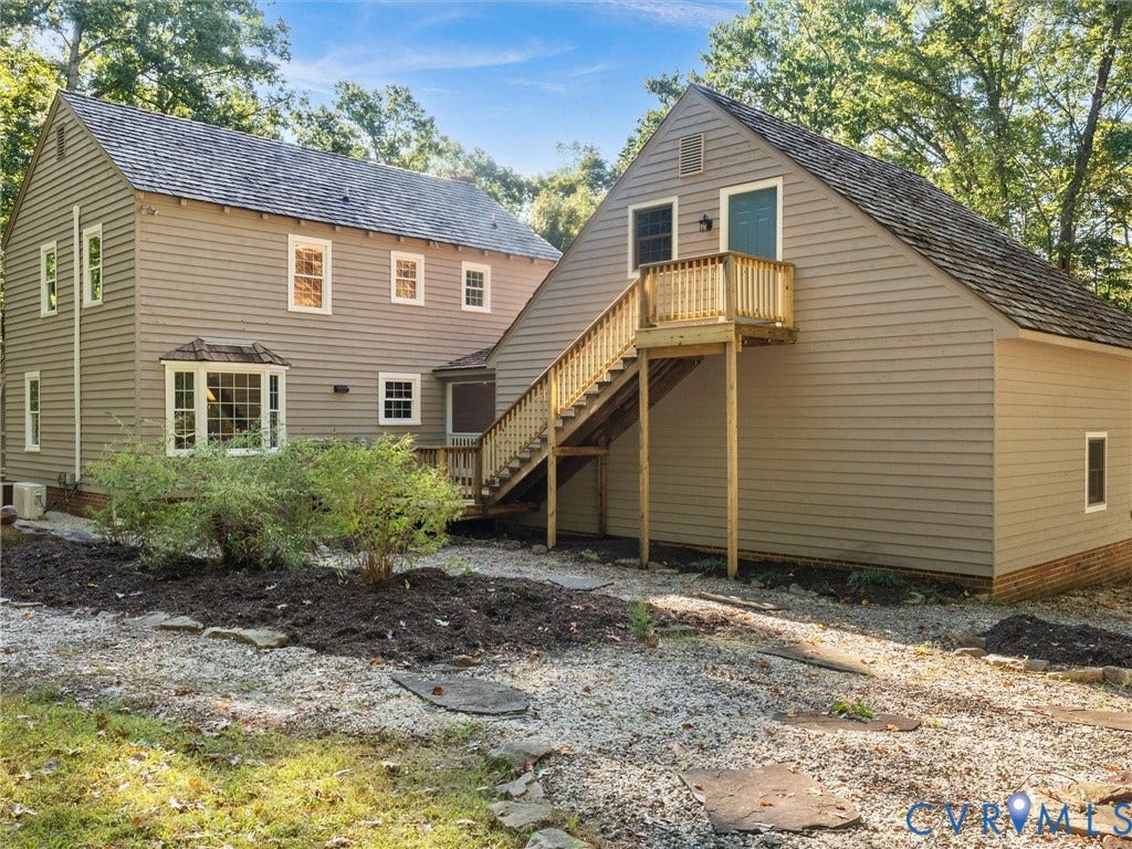 3801 Old River Trail, Powhatan, VA 23139 Exterior featuring horizontal lap siding, a wood-shingle roof, a bay window, and an elevated wood staircase leading to a second-level entrance