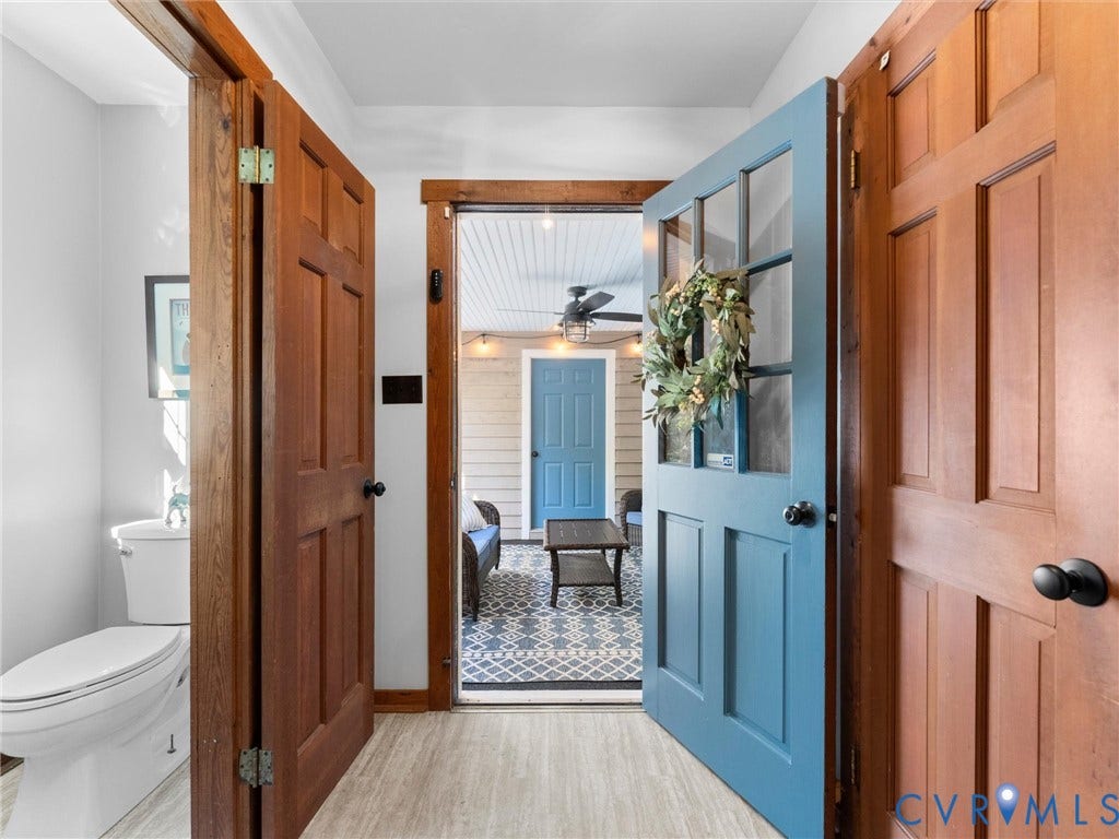 3801 Old River Trail, Powhatan, VA 23139 Entryway featuring solid wood-finish doors with matte black hardware, a multi-pane blue door, and a porcelain toilet