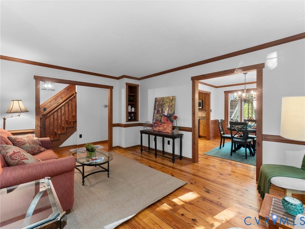 3801 Old River Trail, Powhatan, VA 23139 Natural wood-finish flooring, dark wood crown molding and trim, built-in shelving, and a wooden staircase