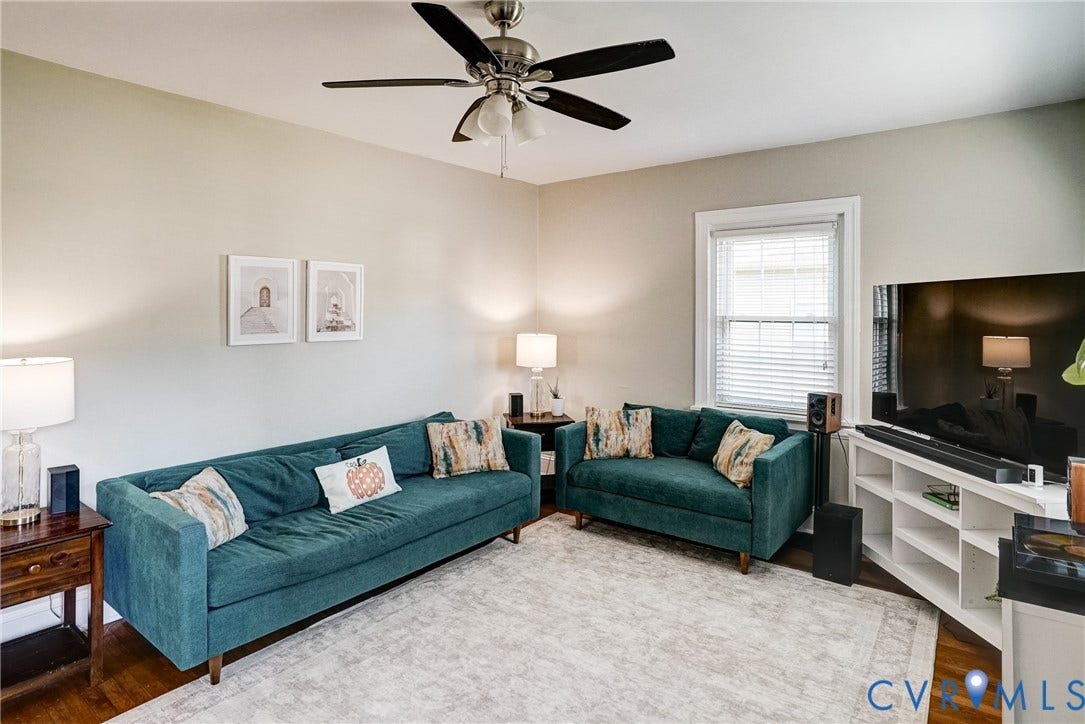 Recessed window, ceiling fan with integrated lighting, and light-toned walls