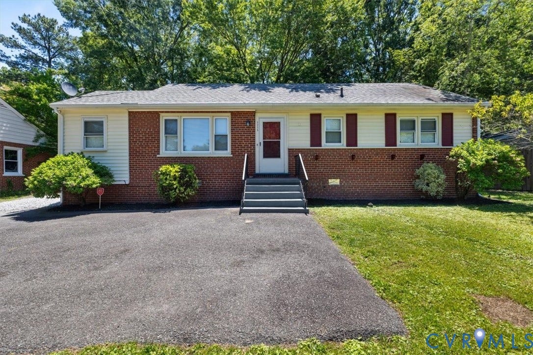1215 Starling Drive, Henrico, VA 23229 Brick and siding exterior with red shutters, a paved driveway, and established landscaping