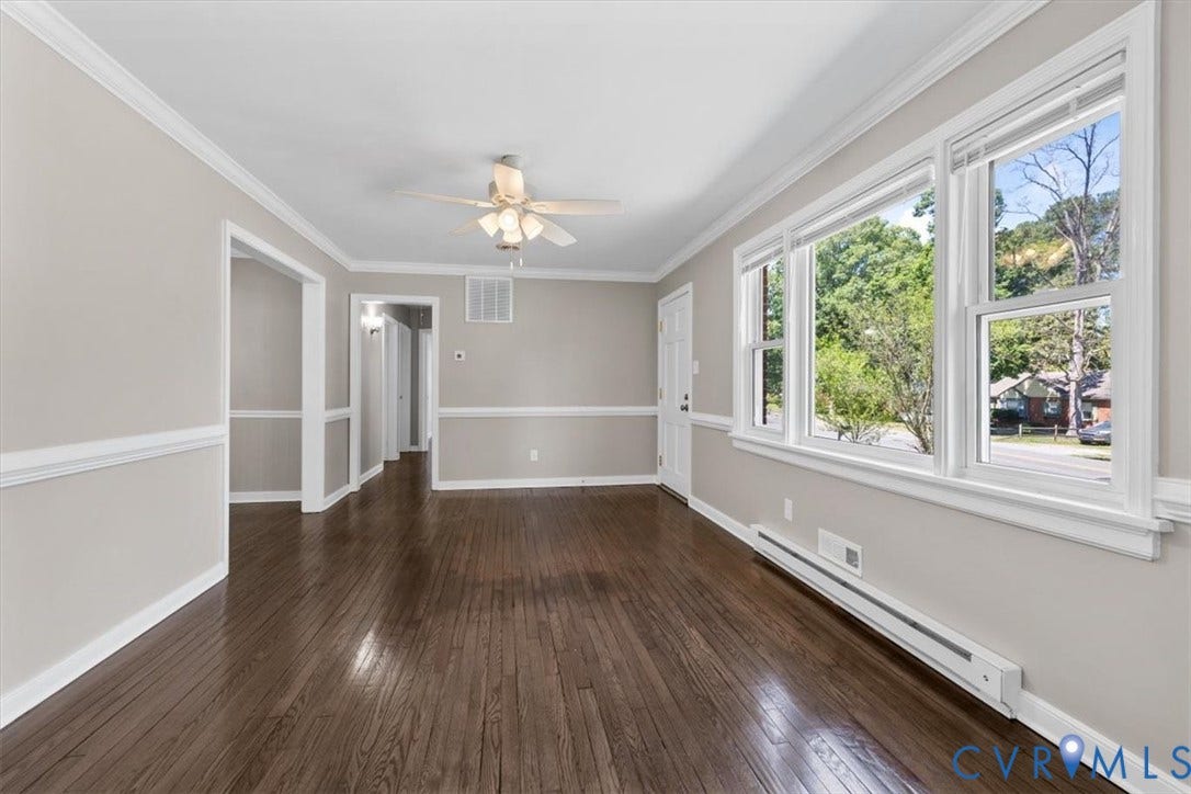 1215 Starling Drive, Henrico, VA 23229 Hardwood flooring, crown molding, chair rail detailing, ceiling fan with light fixture, and multiple windows